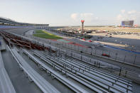 An empty grandstand, foreground, is viewed as drivers head through the front stretch and into Turn 1 during an IndyCar auto race at Texas Motor Speedway in Fort Worth, Texas, Saturday, June 6, 2020. (AP Photo/Tony Gutierrez)