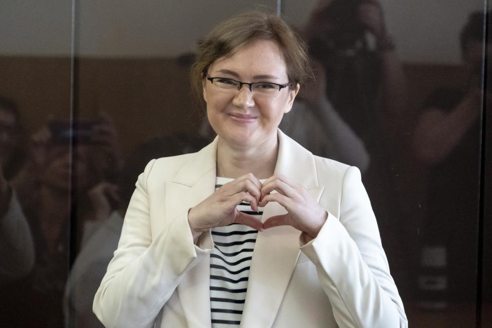 FILE - Lilia Chanysheva makes a heart gesture as she stands in a cage during a hearing in Kirovskiy District Court in Ufa, Russia, on Wednesday, June 14, 2023. Chanysheva, who used to head imprisoned opposition leader Alexei Navalny's office in the Russian region of Bashkortostan, was convicted of extremism charges and sentenced to 7.5 years in prison. (AP Photo, File)