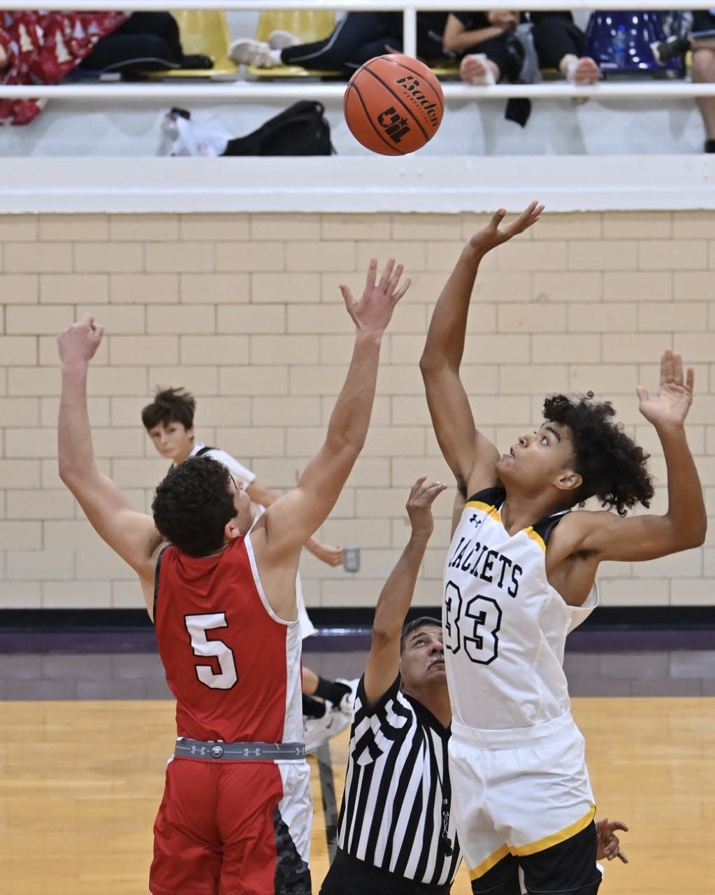 Sonora High School's Jackson Carroll (5) and Menard's Isaiah Stanislawski (33) tip off at the Ozona Basketball Tournament Thursday, Dec. 2, 2021.