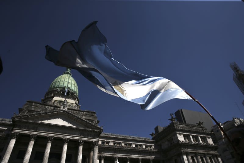 The Argentinian flag flutters in March 2018 outside the congress in Buenos Aires. Around 20 police officers reportedly got injured as at least 18 demonstrators were arrested Wednesday and nine hospitalized in scenes some said looked like a “battlefield” while police attempted to clear a nearby plaza. Photo Provided by David Fernandez/EPA-EFE