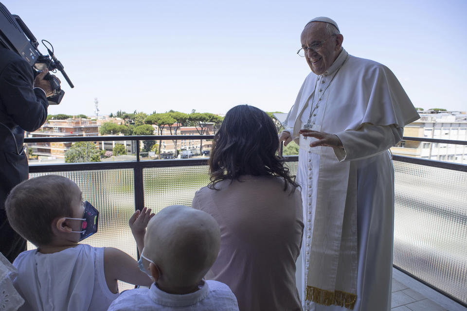 Pope Francis appears with some young oncologic patients at a balcony of the Agostino Gemelli Polyclinic in Rome, Sunday, July 11, 2021, where he was hospitalized for intestine surgery, to deliver his traditional Sunday blessing. (Vatican Media via AP)