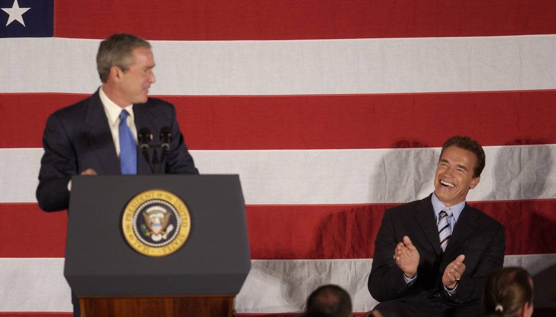 President George W. Bush gets a laugh from Gov.-elect Arnold Schwarzenegger during his speech about terrorism, Iraq and the economy at the Radisson Hotel and Convention Center in San Bernardino on Oct. 16, 2003. John Decker/Sacramento Bee file