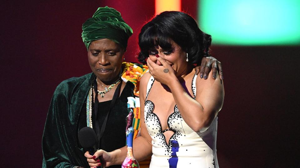 RAYE accepts the Brit Award for Album of the Year with her grandmother by her side (Gareth Cattermole/Getty Images)