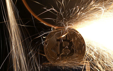 Sparks glow from broken Bitcoin (virtual currency) coins in this illustration picture, December 8, 2017. Picture taken December 8. REUTERS/Dado Ruvic/Illustration