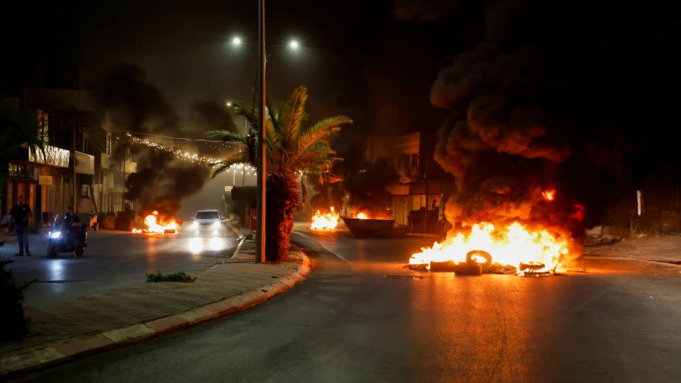 Tires were set on fire on a street during the attacks on Jenin. - Raneen Sawafta/Reuters