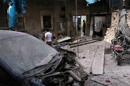 Medics inspect the damage outside a field hospital after an airstrike in the rebel-held al-Maadi neighbourhood of Aleppo, Syria, September 28, 2016. REUTERS/Abdalrhman Ismail