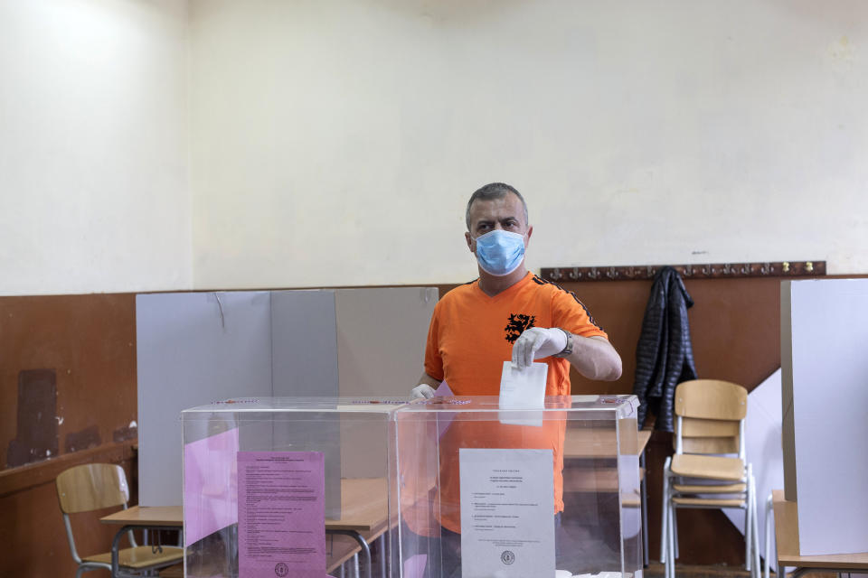Sergej Trifunovic, the leader of the Free Citizens Movement (PSG), an opposition party, casts his ballot for the parliamentary election at a polling station in Belgrade, Serbia, Sunday, June 21, 2020. Serbia's ruling populists are set to tighten their hold on power in a Sunday parliamentary election held amid concerns over the spread of the coronavirus in the Balkan country and a partial boycott by the opposition. (AP Photo/Marko Drobnjakovic)