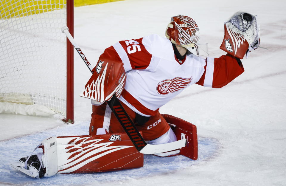 Detroit Red Wings goalie Magnus Hellberg grabs a shot during first-period NHL hockey game action against the Calgary Flames in Calgary, Alberta, Thursday, Feb. 16, 2023. (Jeff McIntosh/The Canadian Press via AP)