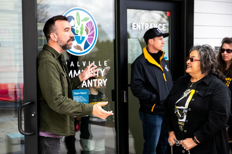 John Boller, executive director of Coralville Community Food Pantry, speaks to fans waiting in line to meet Caitlin Clark during a donation event, Friday, April 21 at 804 13th Avenue.
