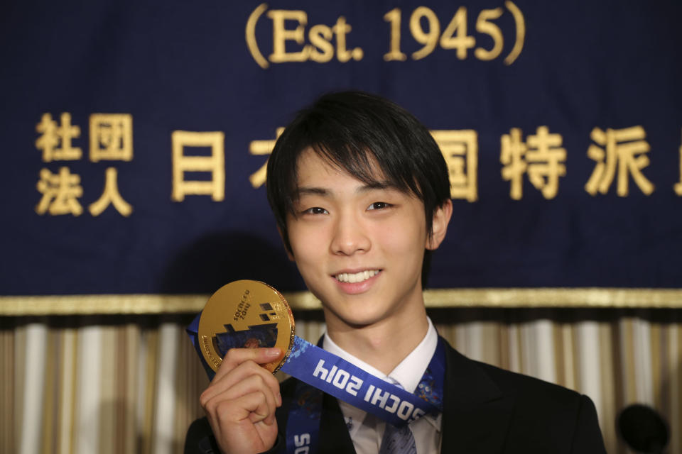 Sochi Winter Olympics men's figure skating gold medalist Yuzuru Hanyu shows his gold medal during a press conference at the Foreign Correspondents' Club of Japan in Tokyo Thursday, April 24, 2014. After winning just about everything there was to win in 2014, Japanese skater Hanyu says there is still room for improvement as he prepares for another season. (AP Photo/Koji Sasahara)