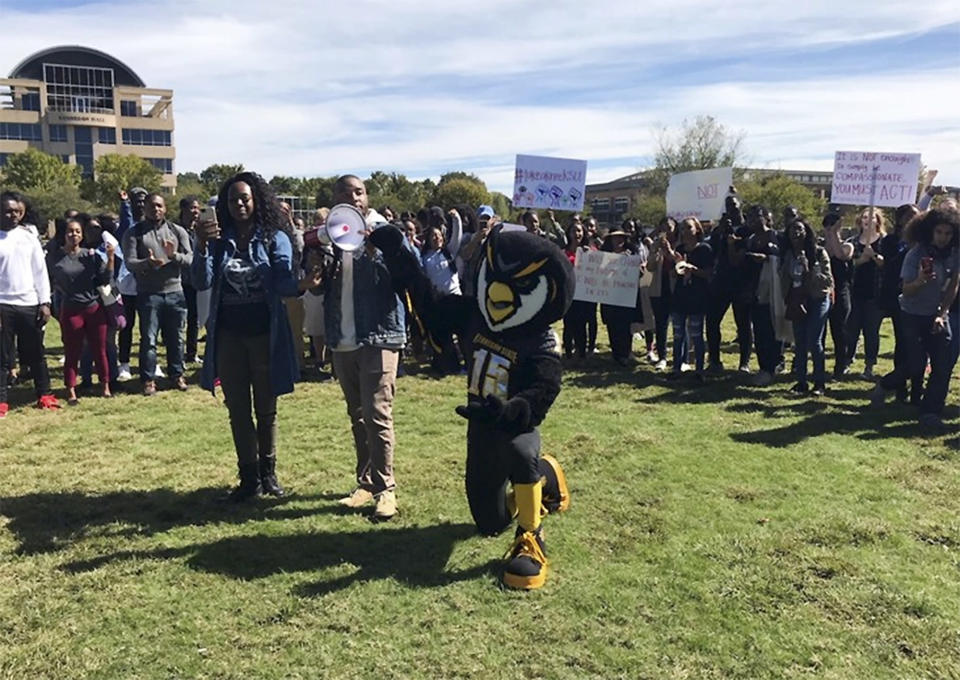 Kennesaw State University students and faculty along with Kenneth Sturkey, who dresses as the university’s mascot Scrappy the Owl, rally in support of five cheerleaders who knelt during the national anthem. Republican state Rep. Earl Ehrhart, who chairs a Georgia House subcommittee in charge of funding the state’s public universities, objected to the mascot’s appearance at the rally. (Atlanta Journal-Constitution via AP)