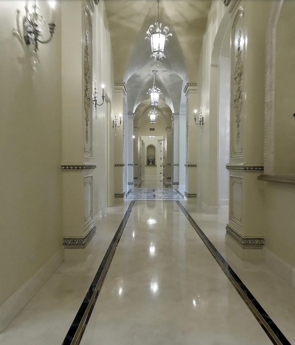 The hallways also have shiny marble floors, as well as extremely high ceilings