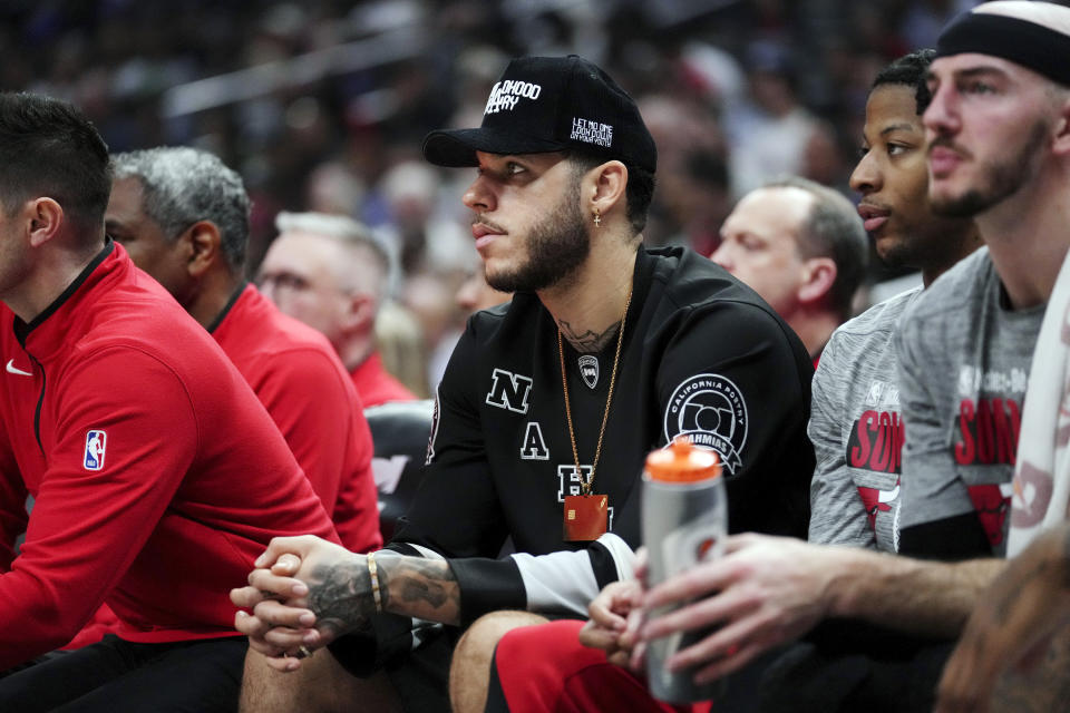 Chicago Bulls guard Lonzo Ball sits on the bench during the first half of an NBA basketball game against the Los Angeles Clippers in Los Angeles, Saturday, March 9, 2024. Coach Billy Donovan said Ball has started sprinting and cutting during on-court drills in controlled, noncontact situations. Ball has not played since January 2022 because of three procedures on his left knee. (AP Photo/Eric Thayer)