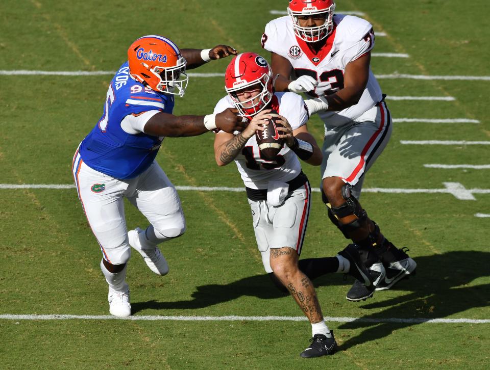 Florida Gators defensive lineman Jamari Lyons (95) makes a tackle on Georgia Bulldogs quarterback Carson Beck (15) during early second quarter action of the annual Florida vs Georgia football game at EverBank Stadium in Jacksonville, FL, Saturday, October 27, 2023. [Bob Self/Florida Times-Union]