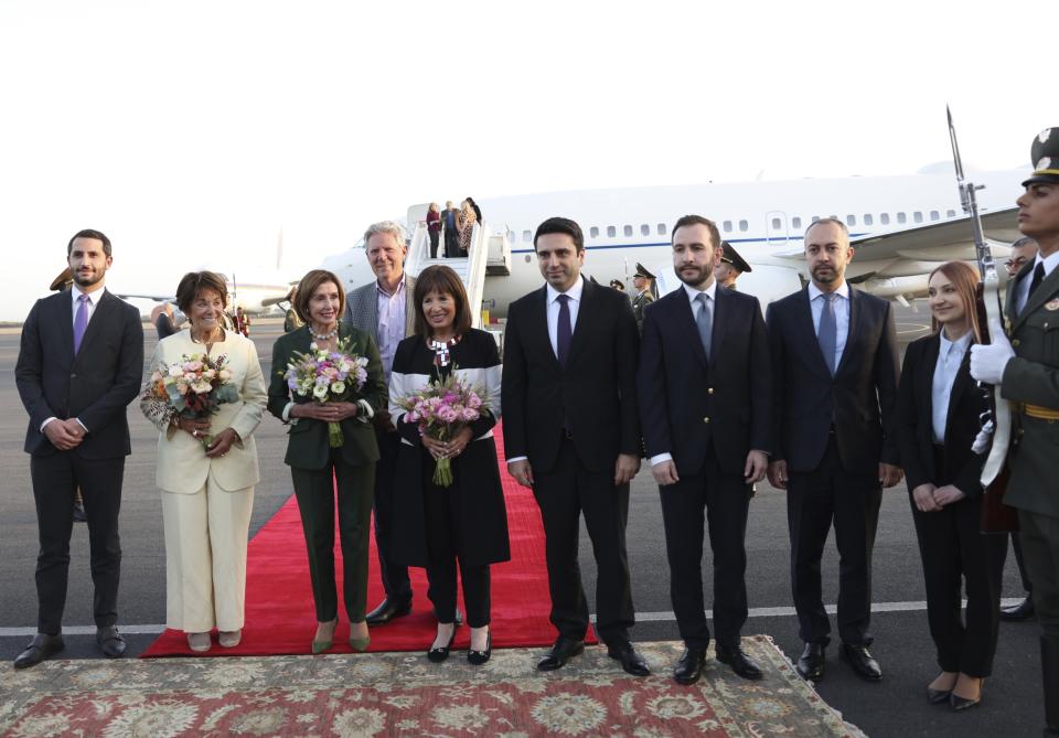 CORRECTS CREDIT - U.S. House of Representatives Nancy Pelosi, third left, and Head of Armenian National Assembly Alen Simonyan, fourth right, pose for a photo with other officials upon arrival at the International Airport outside of Yerevan, Armenia, Saturday, Sept. 17, 2022. A US Congressional delegation headed by Speaker of the House Nancy Pelosi arrived Saturday in Armenian, where a cease-fire has held for three days after an outburst of fighting with neighboring Azerbaijan that killed more than 200 troops from both sides.