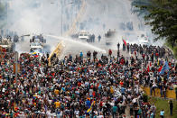 <p>Opposition supporters clash with riot police during a rally against President Nicolas Maduro in Caracas, Venezuela, May 3, 2017. (Christian Veron/Reuters) </p>