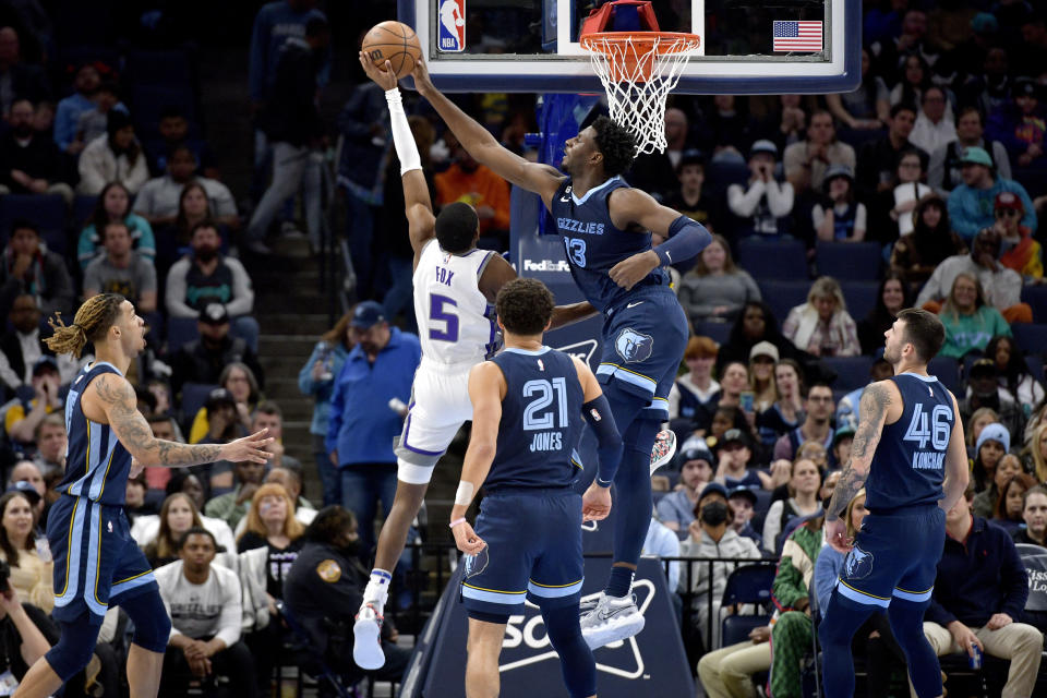 Memphis Grizzlies forward Jaren Jackson Jr. shoots Sacramento Kings guard DeAaron Fox, 5, during the first half of an NBA basketball game in Memphis, Tennessee, Tuesday, November 22, 2022. (AP Photo/Brandon Dill)