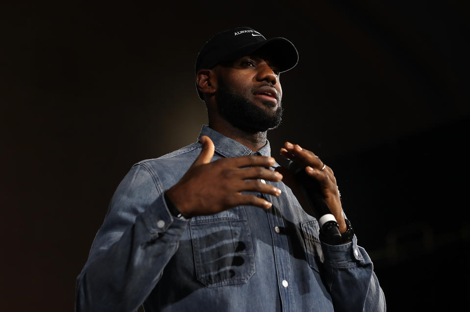 LeBron James holds up his hands to speak.