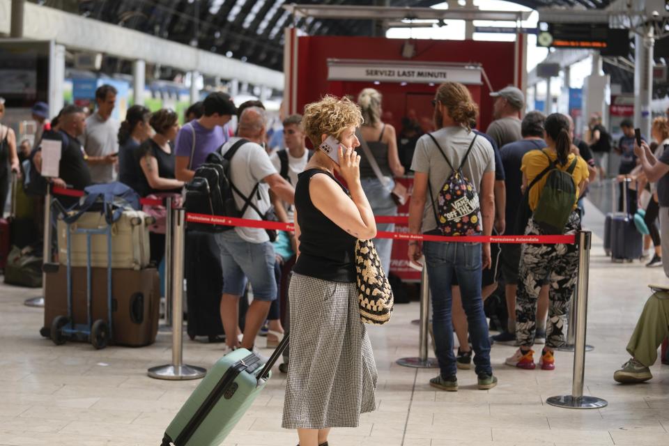 Passengers queue at a Trenitalia ticket office at Milan central station during a national train strike, Thursday, July 13, 2023. Trenitalia and Italo train workers are on strike to demand better working conditions and training. in Milan, Italy, Thursday, July 13, 2023. (AP Photo/Luca Bruno)