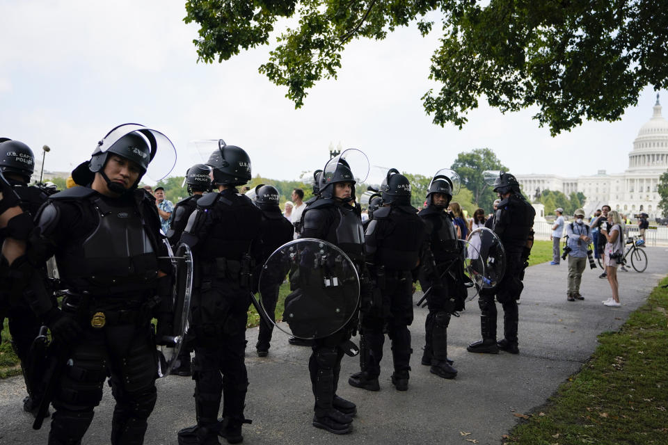 Police in riot gear patrol during a rally near the U.S. Capitol in Washington, Saturday, Sept. 18, 2021. The rally was planned by allies of former President Donald Trump and aimed at supporting the so-called "political prisoners" of the Jan. 6 insurrection at the U.S. Capitol. (AP Photo/Brynn Anderson)