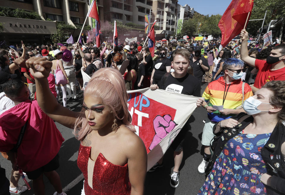 Hundreds of protesters march in Sydney, Saturday, March 6, 2021, ahead of the annual Gay and Lesbian Mardi Gras. The protesters say they want to restore the protest roots of Mardi Gras and challenge systems of injustice. (AP Photo/Rick Rycroft)