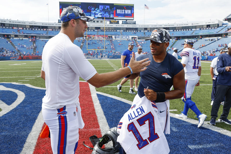 Buffalo Bills quarterback Josh Allen, left, and Denver Broncos quarterback Russell Wilson greet one another after they exchange jerseys after a preseason NFL football game, Saturday, Aug. 20, 2022, in Orchard Park, N.Y. (AP Photo/Jeffrey T. Barnes)