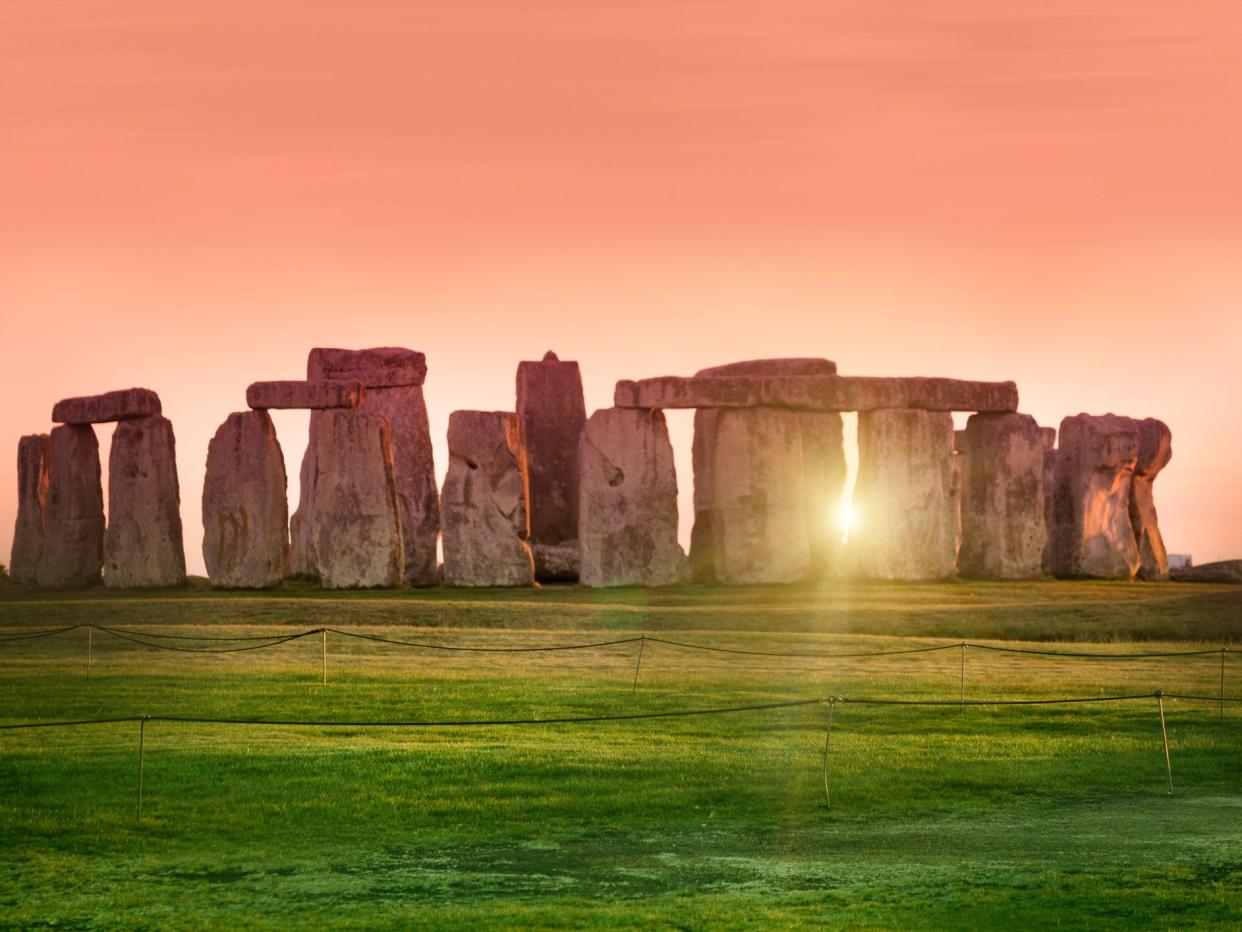 The prehistoric monument of Stonehenge in England. Focus is on the grass.