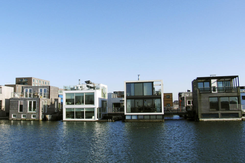 In this photo taken Wednesday, March 28, 2012 amphibious houses float on the harbor in the IJburg neighborhood in Amsterdam. IJburg is a new district in the eastern part of town completely surrounded by water. The Netherlands, a third of which lies below sea level, has been managing water since the Middle Ages and has thus emerged as a pioneer in the field, exporting its expertise to Indonesia, China, Thailand, Dubai and the Republic of the Maldives, an Indian Ocean archipelago that with a maximum elevation of about 2 meters (8 feet) is the world's lowest country. (AP Photo/Margriet Faber)