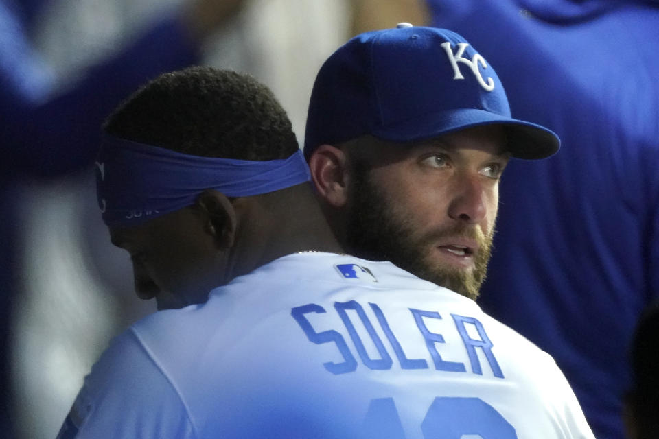 Kansas City Royals starting pitcher Danny Duffy is congratulated by Jorge Soler in the dugout after Duffy got his 1,000 career strikeout during the fourth inning of a baseball game against the Tampa Bay Rays Monday, April 19, 2021, in Kansas City, Mo. (AP Photo/Charlie Riedel)