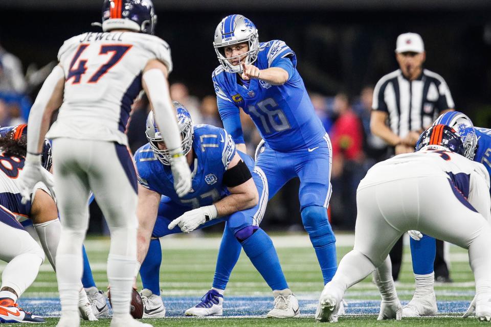 Detroit Lions quarterback Jared Goff (16) talks to center Frank Ragnow (77) before a snap against the Denver Broncos during the second half at Ford Field in Detroit on Saturday, Dec. 16, 2023.