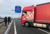 Migrants face off with a trucker on the A16 highway near Calais