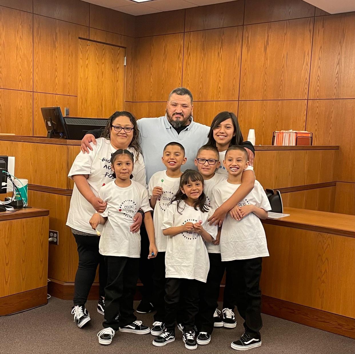 Ruby Celada and Armando Ayala with the six children they adopted on Wednesday, March 24, 2022.