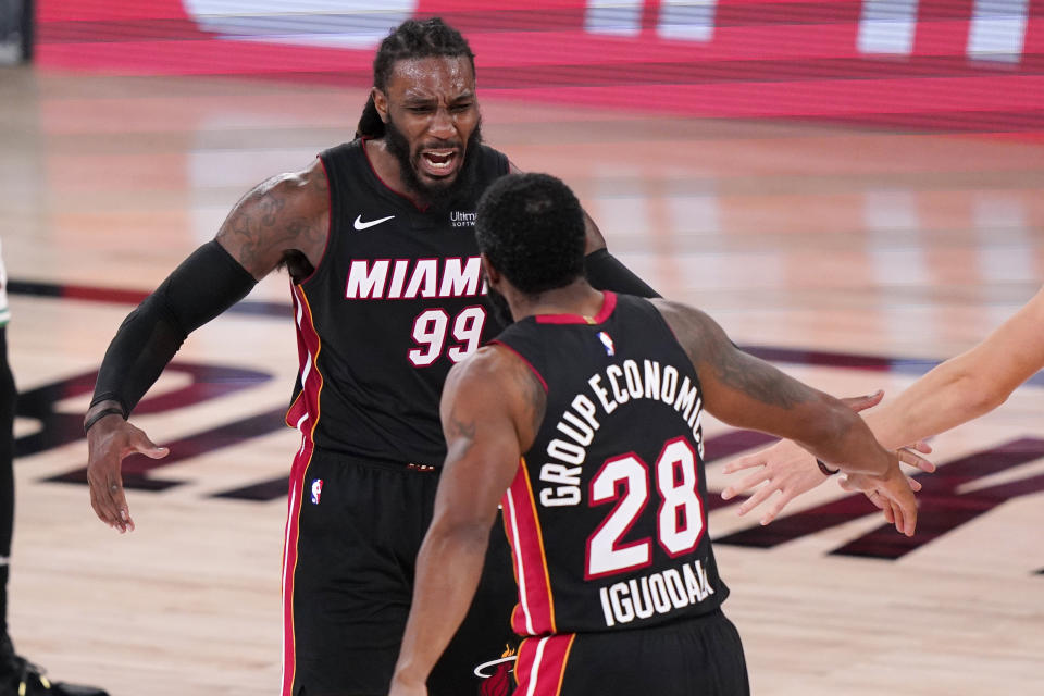 Miami Heat's Jae Crowder (99) and teammate Andre Iguodala (28) celebrate a basket during the second half of an NBA conference final playoff basketball game against the Boston Celtics Sunday, Sept. 27, 2020, in Lake Buena Vista, Fla. (AP Photo/Mark J. Terrill)
