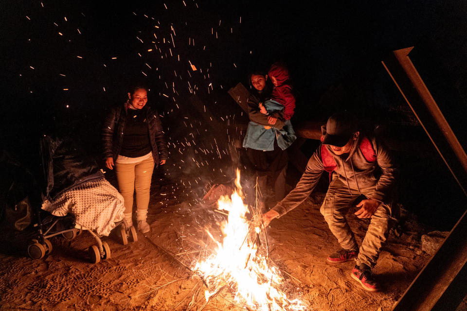 Migrants and asylum seekers are detained by U.S. Border Patrol agents after crossing the U.S.-Mexico border in Yuma County, near the Cocopah Indian Tribe's reservation on Dec. 8, 2022. Border Patrol agents estimated the group to be about 700 people.