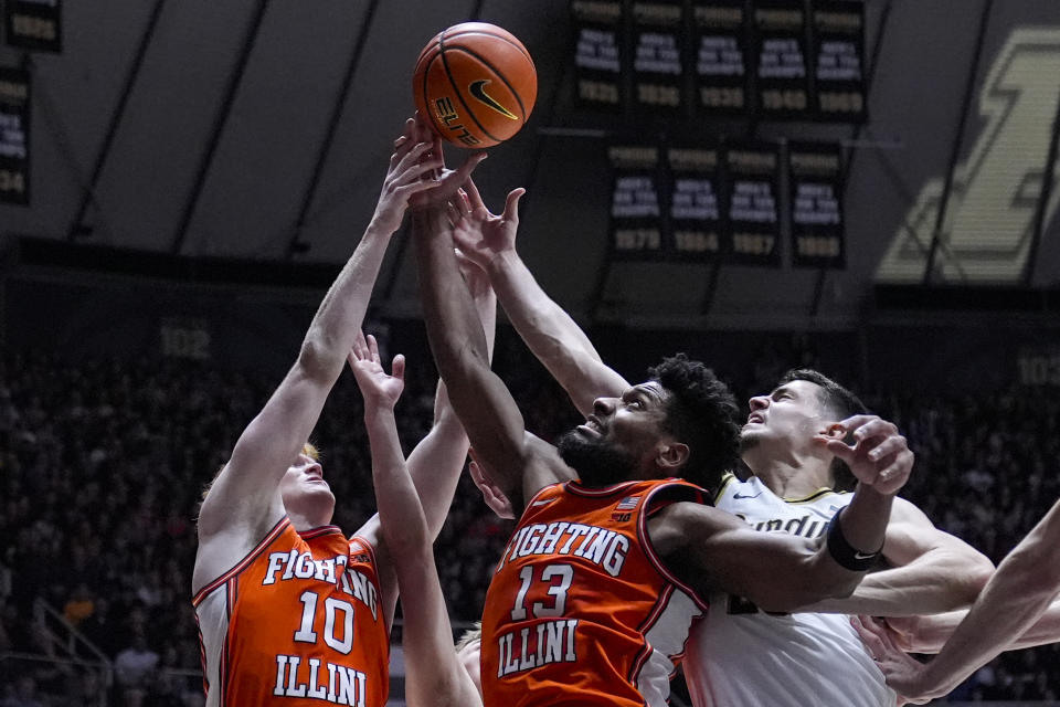 Purdue forward Camden Heide, right, goes up for a rebound with Illinois guard Luke Goode (10) and forward Quincy Guerrier (13) during the first half of an NCAA college basketball game in West Lafayette, Ind., Friday, Jan. 5, 2024. (AP Photo/Michael Conroy)