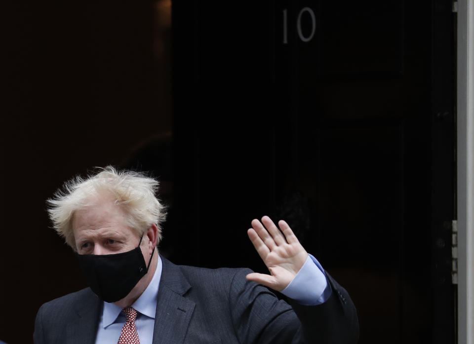 Britain's Prime Minister Boris Johnson waves to the media as he leaves 10 Downing Street or go to the House of Commons his weekly Prime Minister's Questions in London, Wednesday, Sept. 30, 2020. (AP Photo/Alastair Grant)