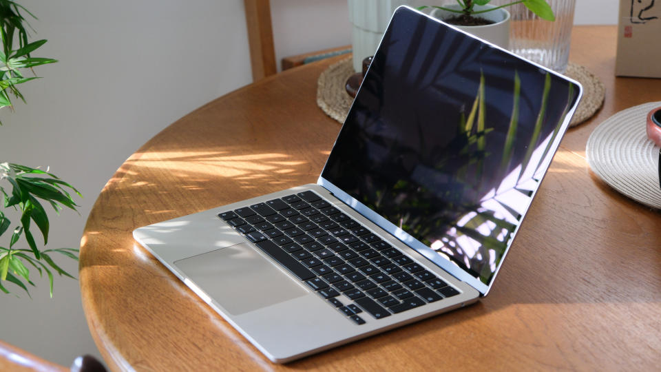 Apple MacBook Air open sitting on a wooden table