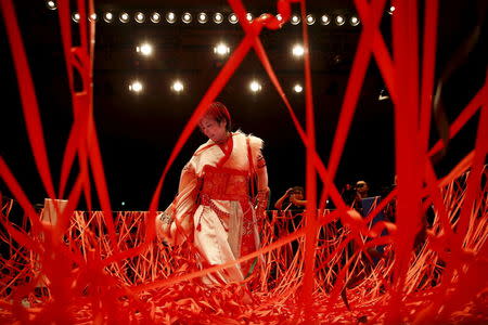 Ticker tape confetti rains on wrestler Act Yasukawa after her last match before retirement during a Stardom female professional wrestling show at Korakuen Hall in Tokyo, Japan, December 23, 2015. Professional women's wrestling in Japan means body slams, sweat, and garish costumes. But Japanese rules on hierarchy also come into play, with a culture of deference to veteran fighters. The brutal reality of the ring is masked by a strong fantasy element that feeds its popularity with fans, most of them men.REUTERS/Thomas Peter TPX IMAGES OF THE DAY SEARCH "WOMEN WRESTLERS" FOR THIS STORY. SEARCH "THE WIDER IMAGE" FOR ALL STORIES