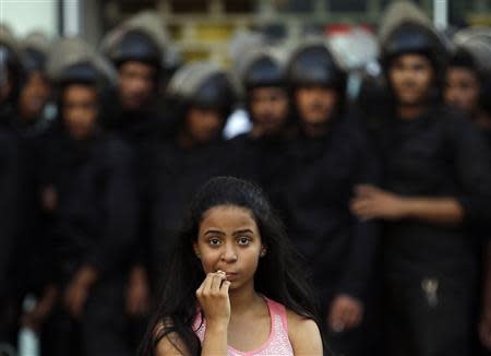 A female activist is pictured in front of riot police during a protest against a new law restricting demonstrations, in downtown Cairo November 26, 2013. REUTERS/Amr Abdallah Dalsh