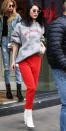 <p>The model made sweats look chic in London in a gray hoodie, red pants, and white block-heel boots. She paired the casual look with sunglasses and a fresh blowout.</p>