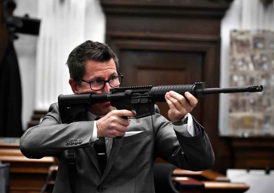 Assistant District Attorney Thomas Binger holds Kyle Rittenhouse&#39;s gun as he gives the state&#39;s closing argument in Kyle Rittenhouse&#39;s trial at the Kenosha County Courthouse on November 15, 2021 in Kenosha, Wisconsin. Rittenhouse is accused of shooting three demonstrators, killing two of them, during a night of unrest that erupted in Kenosha after a police officer shot Jacob Blake seven times in the back while being arrested in August 2020. Rittenhouse, from Antioch, Illinois, was 17 at the time of the shooting and armed with an assault rifle. He faces counts of felony homicide and felony attempted homicide.