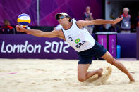 LONDON, ENGLAND - AUGUST 06: Emanuel Rego (playing partner of Alison Cerutti) of Brazil reacts attempts to return the ball against Mariusz Prudel and Grzegorz Fijalek of Poland during the Men's Beach Volleyball a quarterfinal match between Brazil and Poland on Day 10 of the London 2012 Olympic Games at Horse Guards Parade August 6, 2012 in London, England. (Photo by Ryan Pierse/Getty Images)