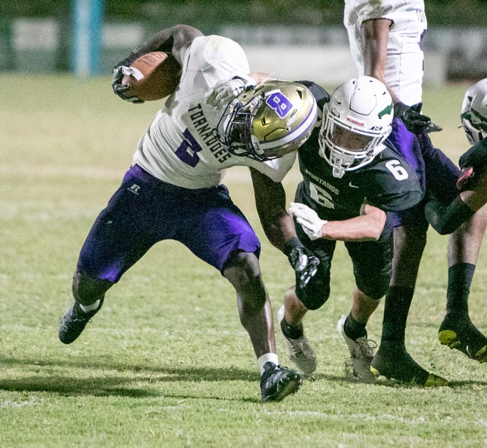 Booker runningback Omarion Patterson (6) is wrapped up by Lakewood Ranch defensive back Jaden Munoz (6) during their teams matchup in Lakewood Ranch.  MATT HOUSTON/HERALD-TRIBUNE