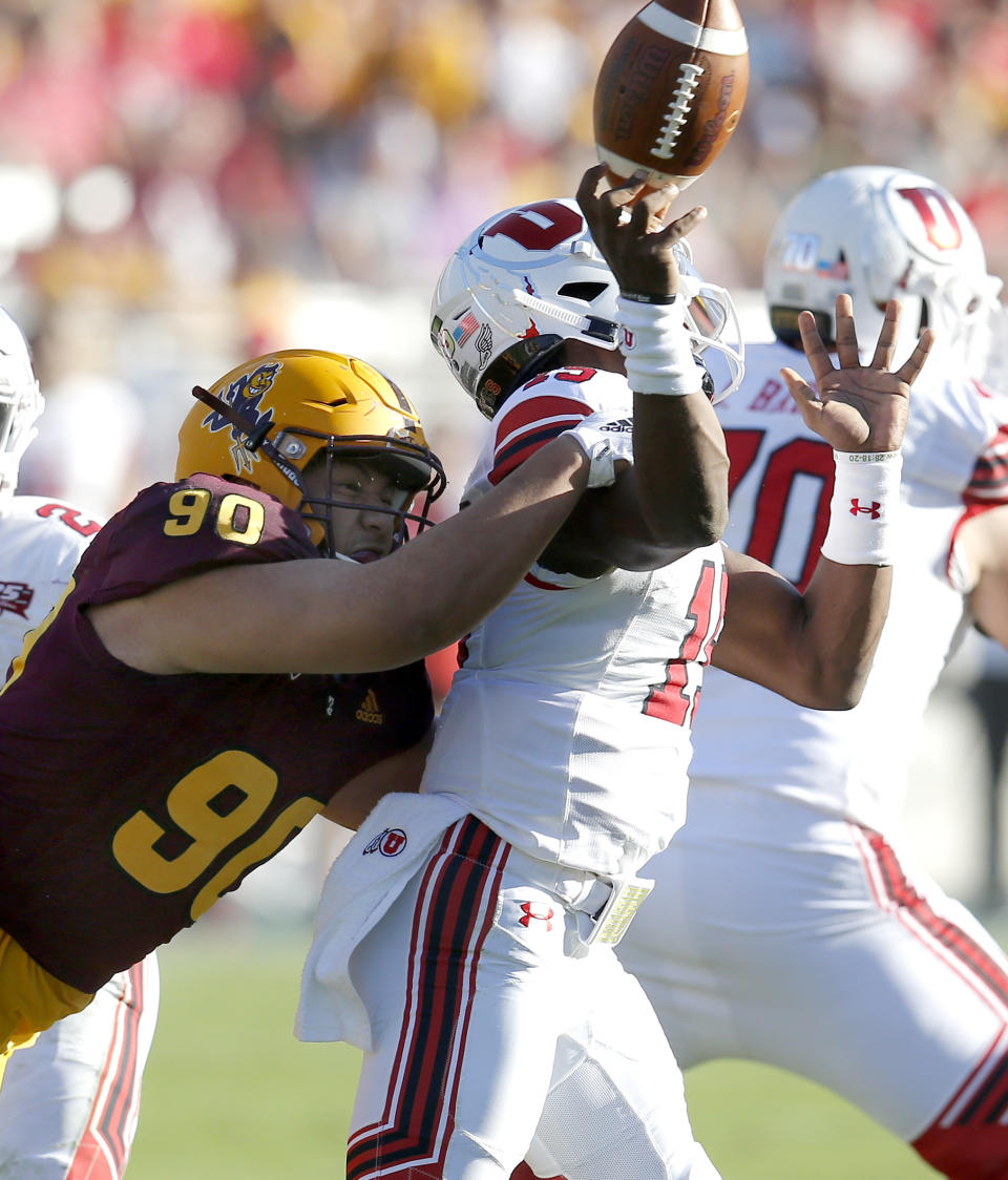 Arizona State defensive lineman Jermayne Lole (90) forces a fumble on Utah quarterback Jason Shelley (15) in the second half during an NCAA college football game, Saturday, Nov. 3, 2018, in Tempe, Ariz. (AP Photo/Rick Scuteri)