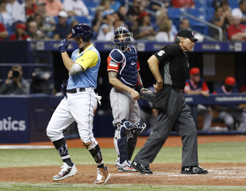 Tampa Bay Rays' Willy Adames, left, celebrates his two-run home run in front Boston Red Sox catcher Blake Swihart during the fourth inning of a baseball game on Friday, Aug. 24, 2018, in St. Petersburg, Fla. (AP Photo/Scott Audette)