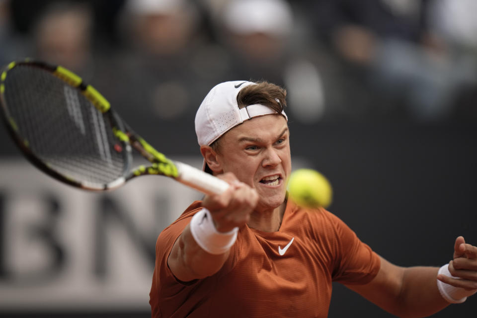 Denmark's Holger Rune returns the ball to Daniil Medvedev of Russia during the men's final tennis match at the Italian Open tennis tournament in Rome, Italy, Sunday, May 21, 2023. (AP Photo/Alessandra Tarantino)
