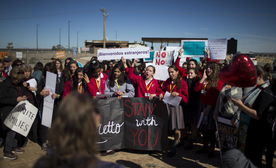 In this Nov. 15, 2018 photo provided by Ivan Pierre Aguirre, students from a local Catholic school protest outside the Tornillo detention camp holding more than 2,300 migrant teens in Tornillo, Texas. The Trump administration announced in June 2018 that it would open the temporary shelter for up to 360 migrant children in this isolated corner of the Texas desert. Less than six months later, the facility has expanded into a detention camp holding thousands of teenagers - and it shows every sign of becoming more permanent. (Ivan Pierre Aguirre via AP)