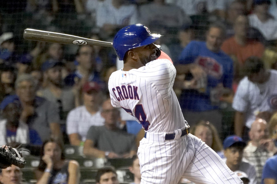 Making his Major League debut, Chicago Cubs' Narciso Crook follows through on an RBI double during the seventh inning of a baseball game against the Cincinnati Reds Thursday, June 30, 2022, in Chicago. (AP Photo/Charles Rex Arbogast)