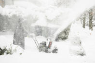 Star Haynes clears snow from her driveway with a snowblower, Saturday, Nov. 19, 2022 in Buffalo, N.Y. Residents of northern New York state are digging out from a dangerous lake-effect snowstorm that had dropped nearly 6 feet of snow in some areas and caused three deaths. The Buffalo metro area was hit hard, with some areas south of the city receiving more than 5 feet by early Saturday. (Libby March /The Buffalo News via AP)