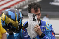 Jimmie Johnson takes off his balaclava during qualifications for the Indianapolis 500 auto race at Indianapolis Motor Speedway, Saturday, May 21, 2022, in Indianapolis. (AP Photo/Darron Cummings)
